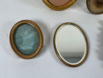 Four small brass picture frames, three with...