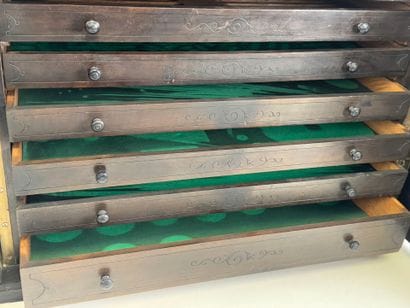 Small cabinet in blackened wood opening with...
