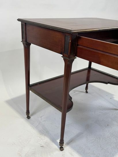 Small mahogany and brass fillet desk on casters,...