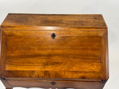 Small wooden sloping desk opening with a...