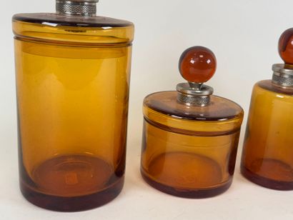 Colored glass and metal toilet set including...