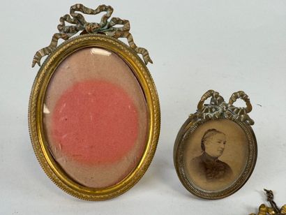 Four small brass picture frames, three with...