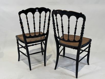 Two chairs in blackened wood with gold highlights,...