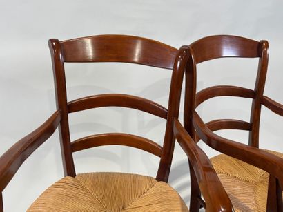 Pair of cherrywood armchairs, straw seat.
20th...