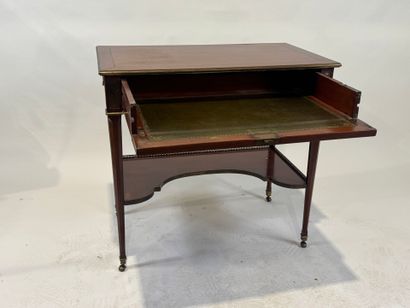 Small mahogany and brass fillet desk on casters,...