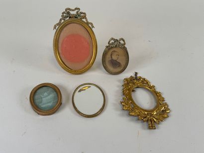 Four small brass picture frames, three with...