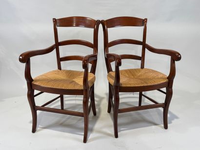 Pair of cherrywood armchairs, straw seat.
20th...