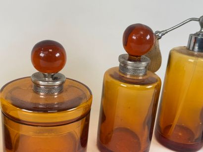 Colored glass and metal toilet set including...