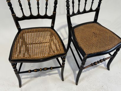 Two chairs in blackened wood with gold highlights,...