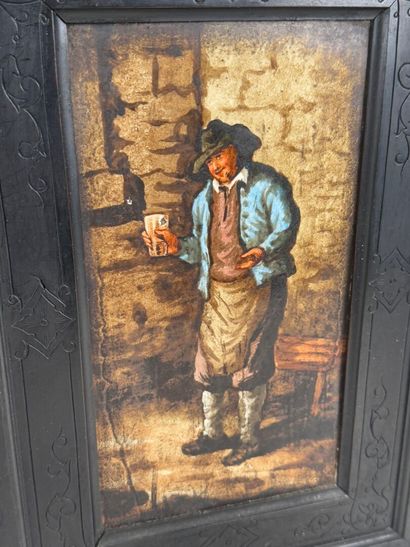 Small cabinet in blackened wood opening with...