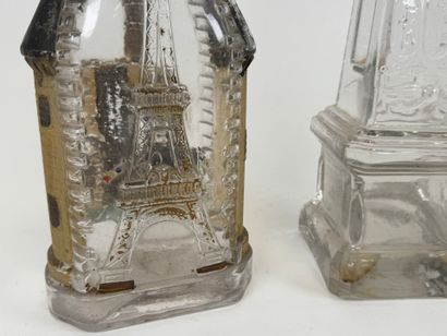 Two glass bottles decorated with an obelisk...