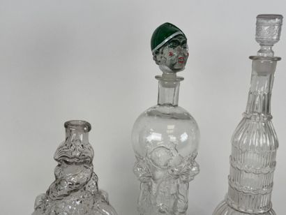 Three glass bottles decorated with stylized...