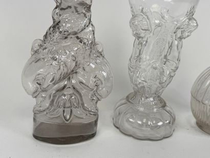 Three glass bottles decorated with stylized...