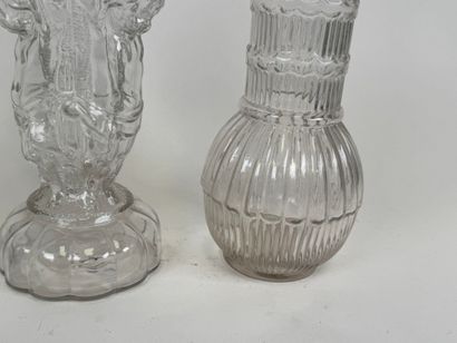 Three glass bottles decorated with stylized...