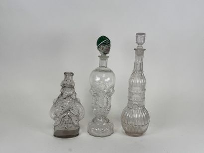 Three glass bottles decorated with stylized...