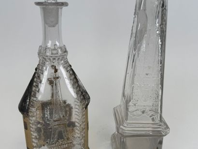 Two glass bottles decorated with an obelisk...