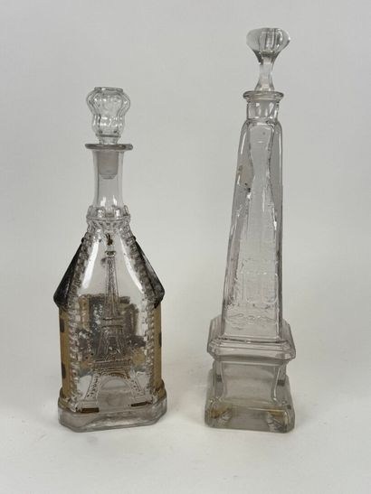Two glass bottles decorated with an obelisk...