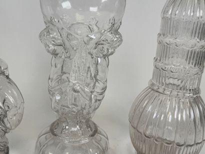 Three glass bottles decorated with stylized...