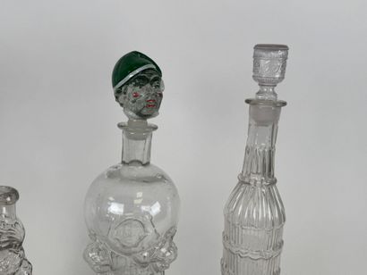 Three glass bottles decorated with stylized...