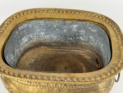 Large jardinière in repoussé brass decorated...