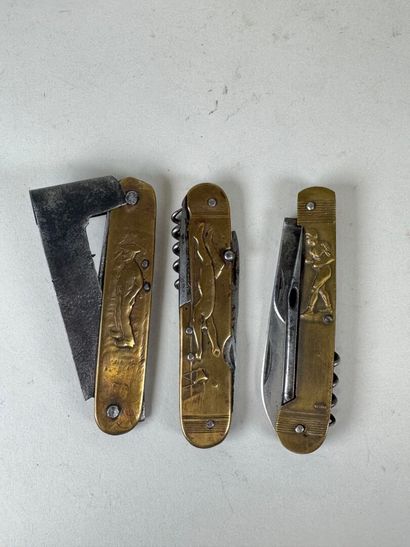 Three brass and steel knives decorated with...