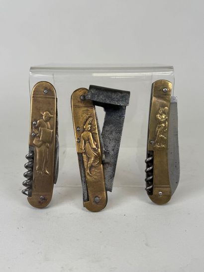 Three brass and steel knives decorated with...