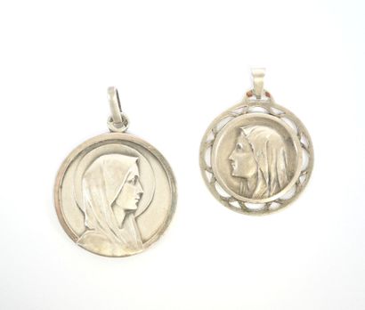 Two circular religious medals in silver decorated...
