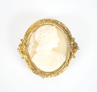 Oval gilt-metal brooch featuring a cameo...