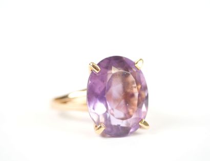 18K yellow gold ring set with an oval faceted...