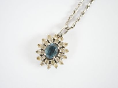 Stylized silver neck chain adorned with a...