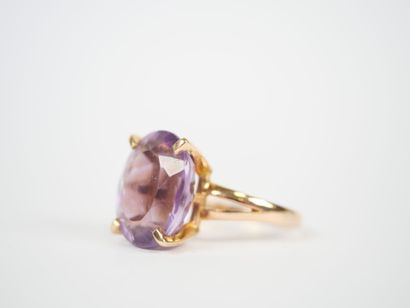 18K yellow gold ring set with an oval faceted...