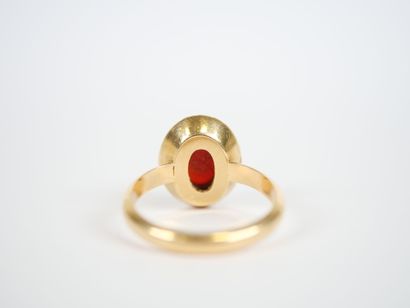 18K yellow gold ring centered with an oval...