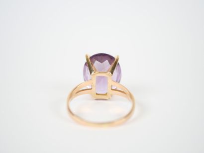 18K yellow gold ring set with an oval faceted...
