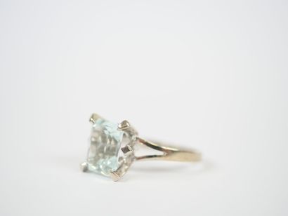 Platinum ring set with an emerald-cut faceted...