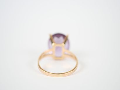 18K yellow gold ring set with an oval faceted...