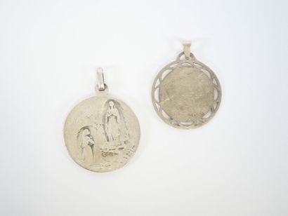 Two circular religious medals in silver decorated...