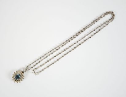 Stylized silver neck chain adorned with a...