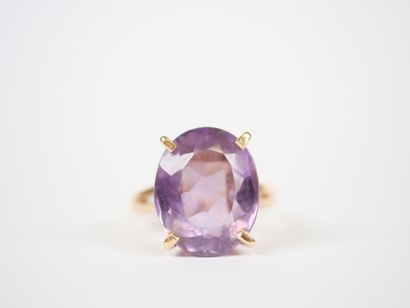 18K yellow gold ring set with an oval faceted...