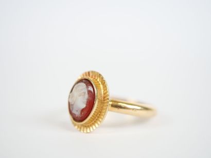 18K yellow gold ring centered with an oval...