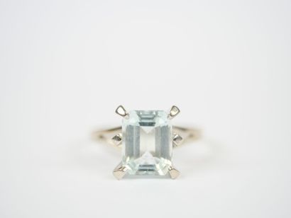 Platinum ring set with an emerald-cut faceted...
