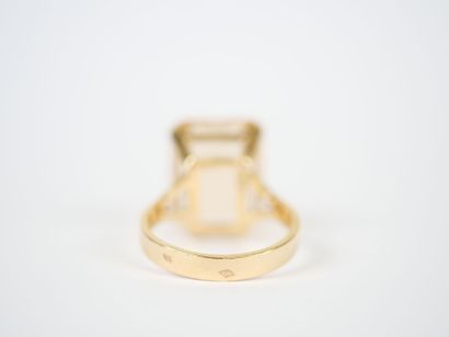 18K yellow gold ring featuring a large faceted...