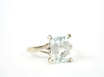 Platinum ring set with an emerald-cut faceted...