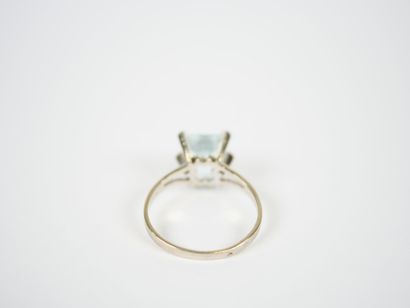 Platinum ring set with an emerald-cut faceted...