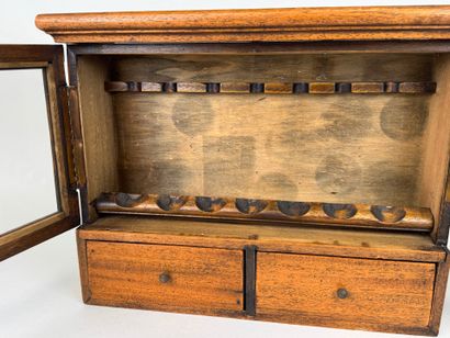 Small pipe cabinet in stained wood opening...