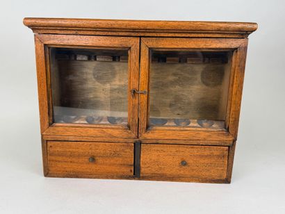 Small pipe cabinet in stained wood opening...