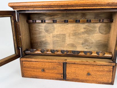 Small pipe cabinet in stained wood opening...