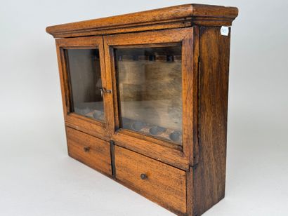 Small pipe cabinet in stained wood opening...
