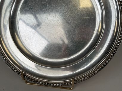 Circular dish decorated with a string of...