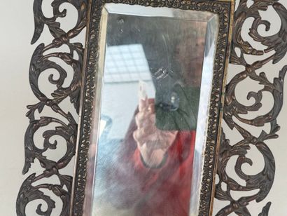 An openwork patinated bronze mirror with...