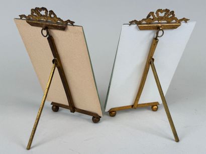 Two beveled glass and brass picture frames...